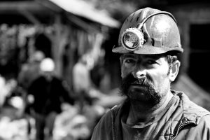 image depicting a male coal miner wearing a hardhat