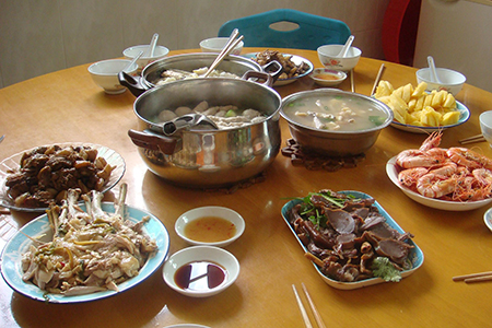 un assortiment des plats chinois sur la table, qui inclut des crevettes, du bœuf et de la soupe