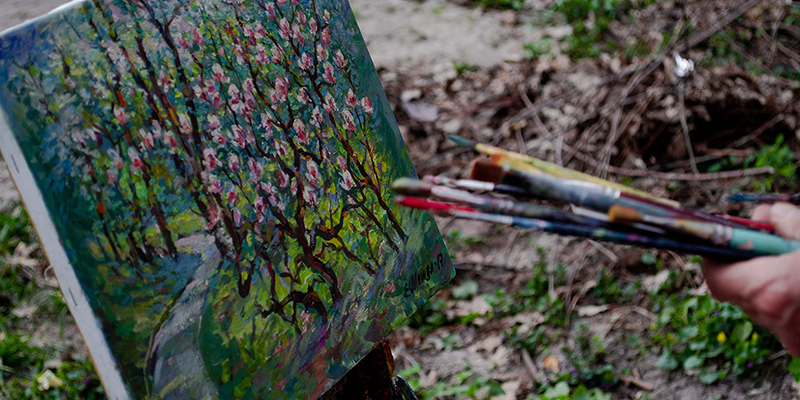 a painting of a tree and paintbrushes