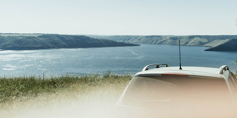 car sitting by a body of water