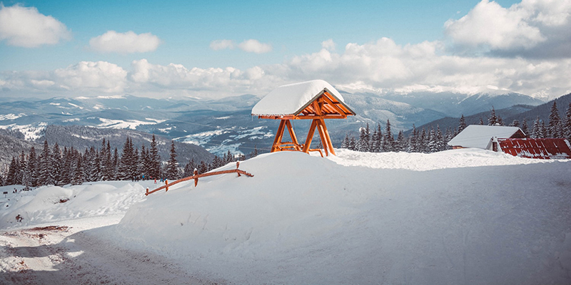 snowy ledge with a snow covered swing