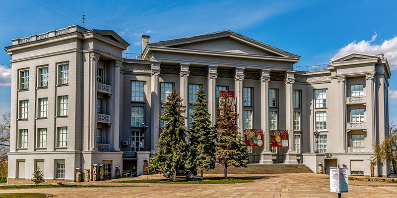 grey building with red banners on it