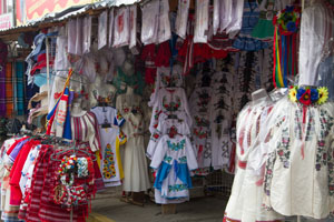 A photo of many embroidered shirts in a shop.