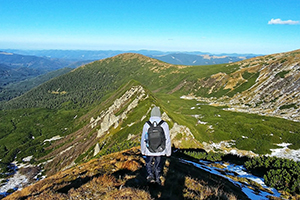 man looking out on mountains