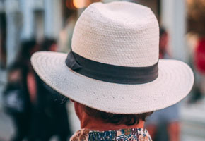 A photo of a man in a white hat with a black band.