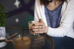 closeup of woman in cafe holding a drink