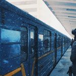 people standing outside metro car