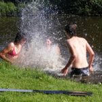 children swimming in river