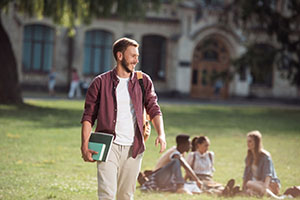 male student walking on college campus